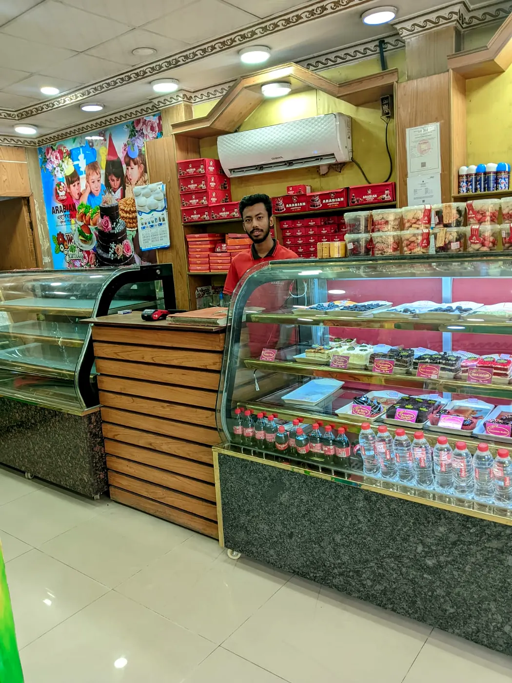 Arabian Cake & Sweets pastry counter with staff